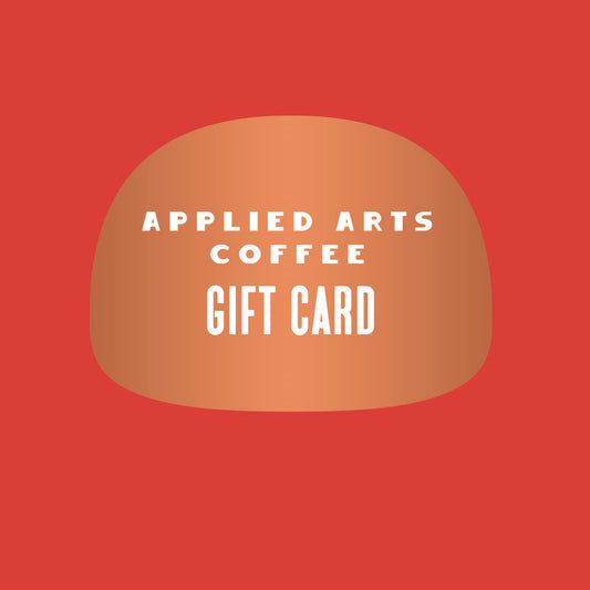 Red background with copper colored shape and white writing stating Applied Arts Coffee Gift Card. This is an image for interest only. Applied Arts Coffee Gift cards are digital, and not a physical card.